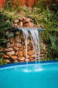 Dive into Luxury: Advantages of Adding Waterfall to Your Pool